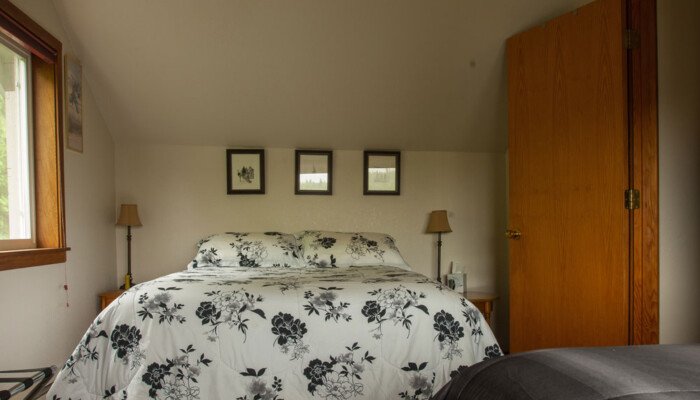 Cozy bedroom with floral bedding and wooden door