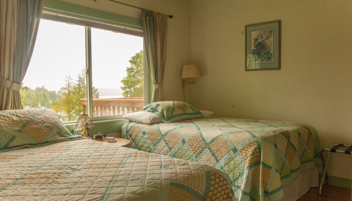 Cozy bedroom with twin beds and scenic window view