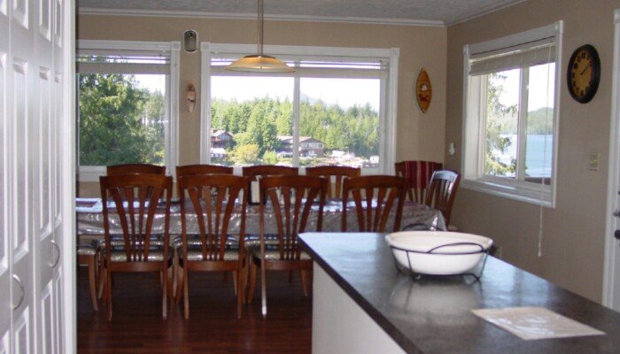 Spacious kitchen overlooking serene lake through large windows