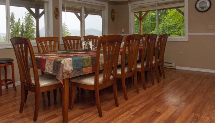 Spacious dining room with wooden table and mountain view