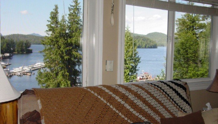 Cozy room interior with lake view and docked boats