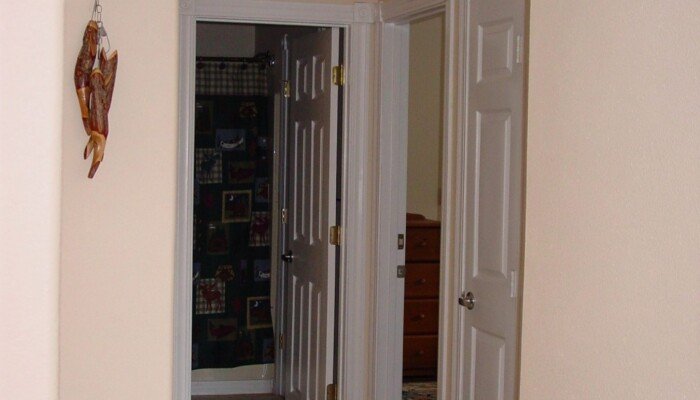 Interior hallway with wooden floors and open doors