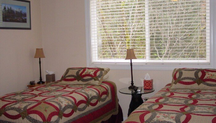 Cozy bedroom with two beds and large window