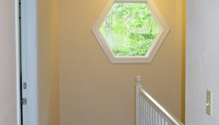 Hallway with wooden floors and octagonal window